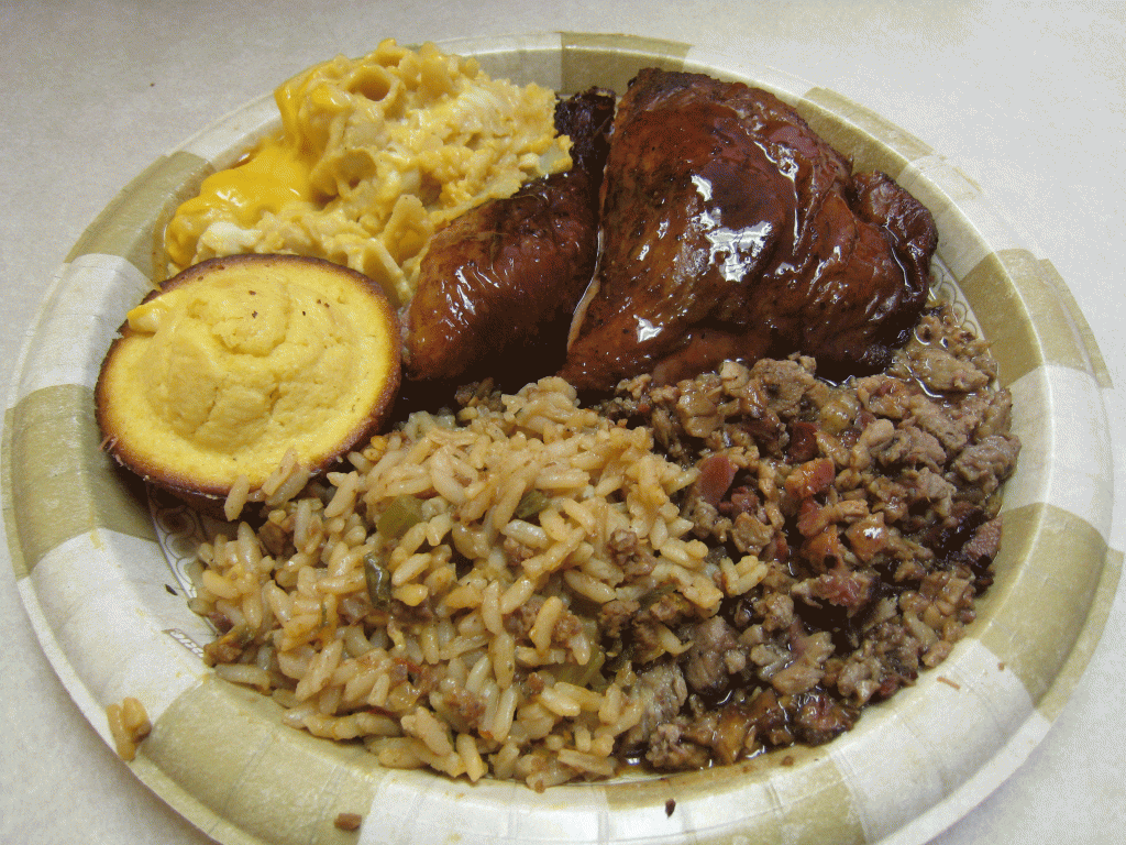 Two meat combo plate: chicken and chopped brisket with dirty rice, cornbread and macaroni and cheese